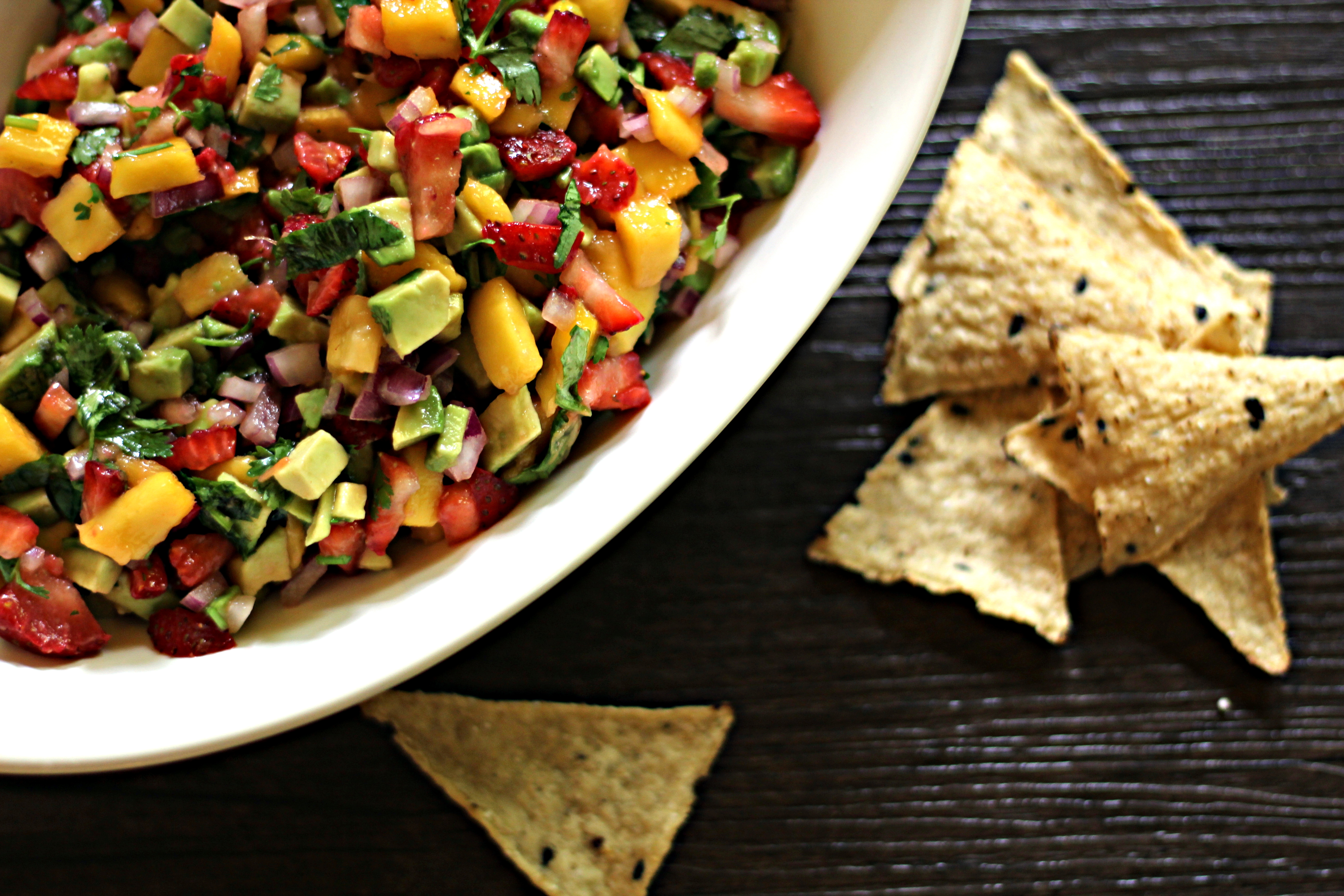 bright fruity summer salsa in a bowl with tortilla chips