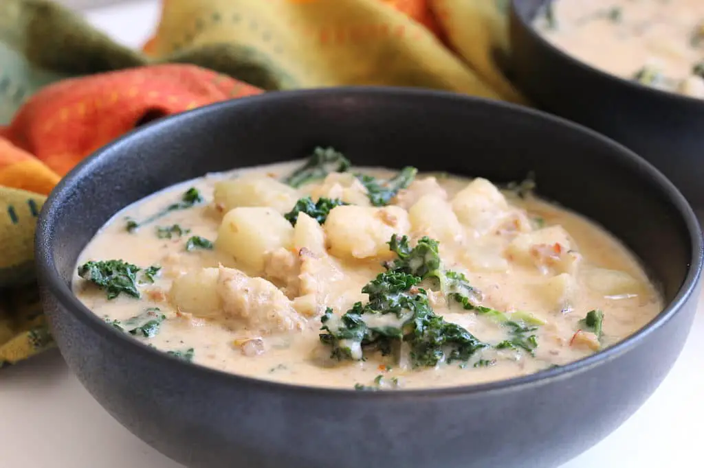 picture of vegan creamy potato sausage kale soup in bowl