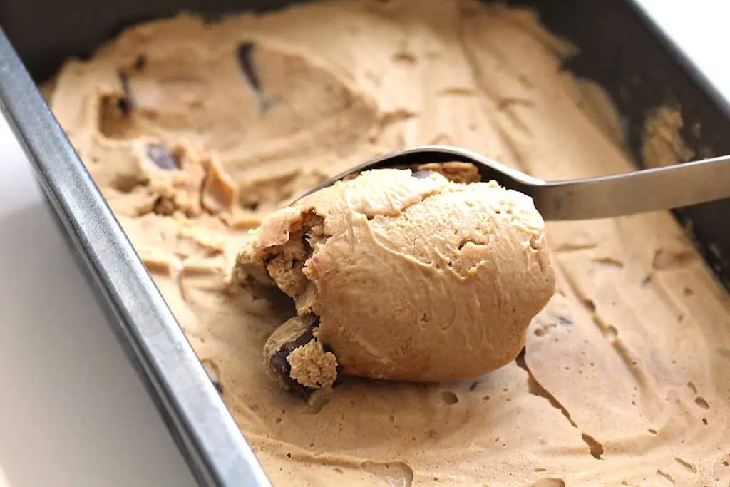 Image of vegan coffee ice cream being scooped from a metal loaf pan
