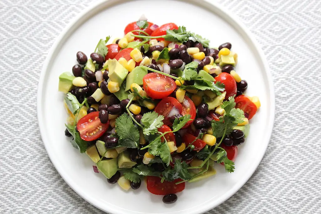 image of black bean corn salad on white plate
