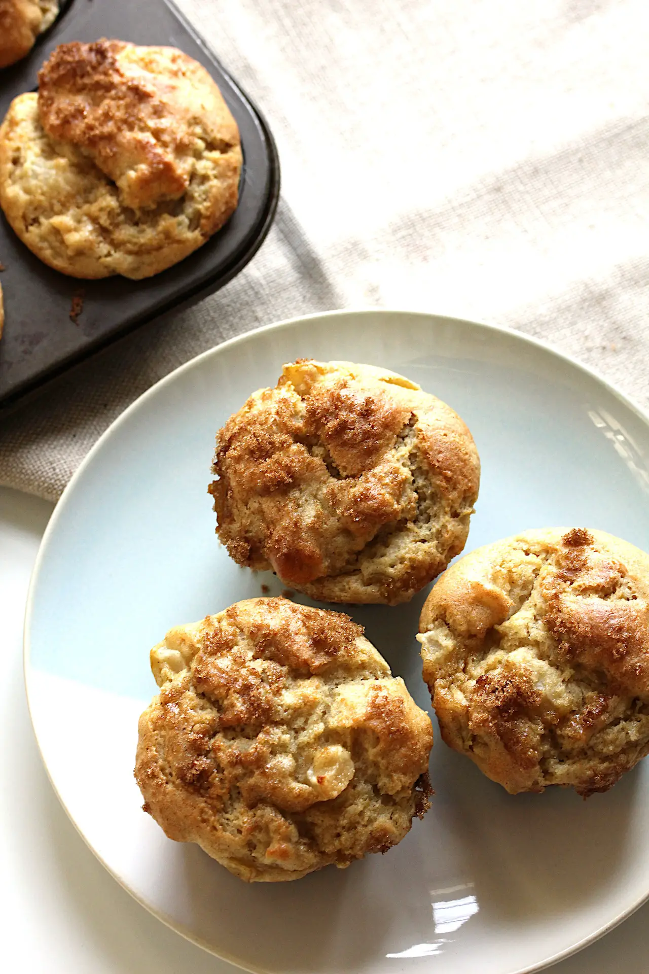 image of three gluten-free pear cardamom muffins on a plate