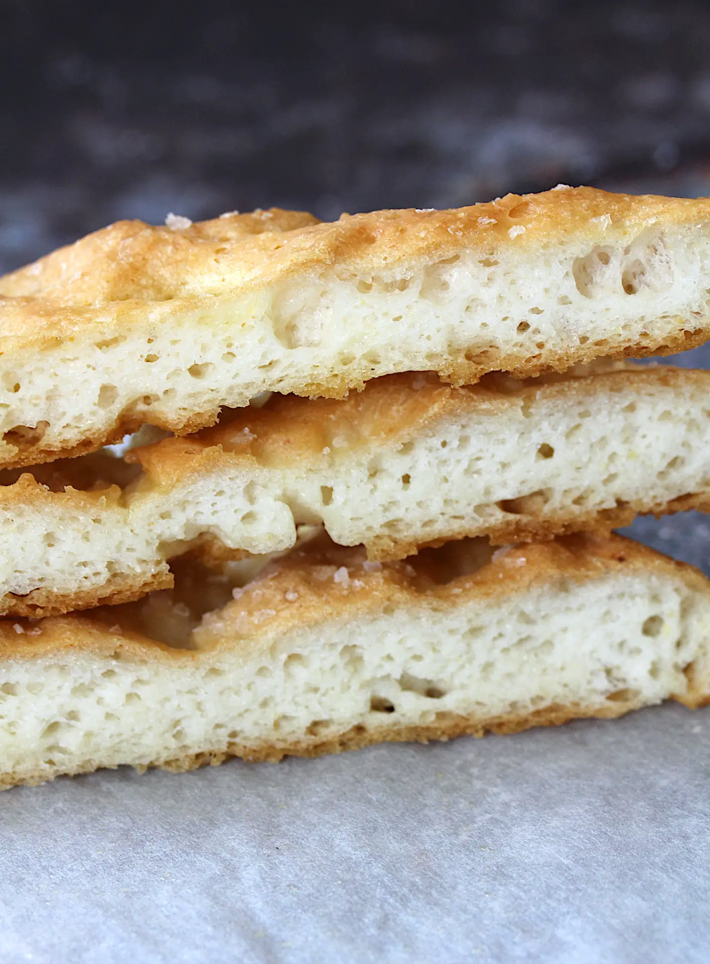 image of the focaccia bread sliced and stacked on top of each other to show the texture of the inside.