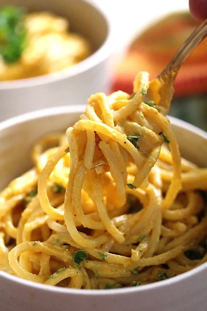 image of a fork pulling up noodles covered in the pumpkin alfredo